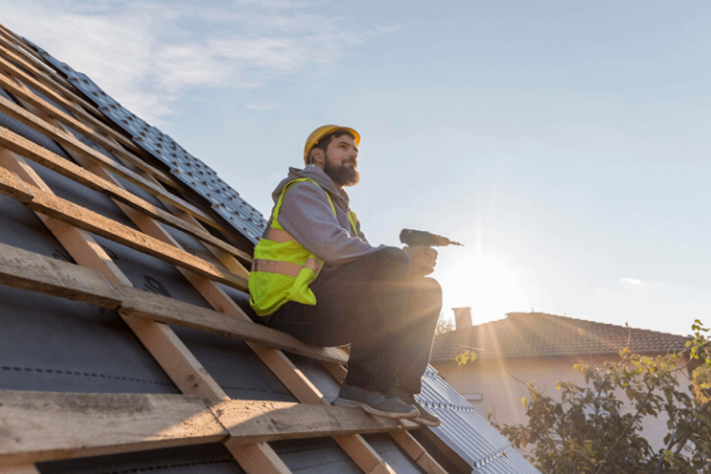 A worker doing the roof replacement.